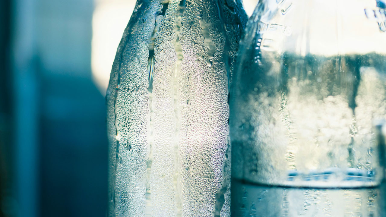 Close-up of two bottles containing water