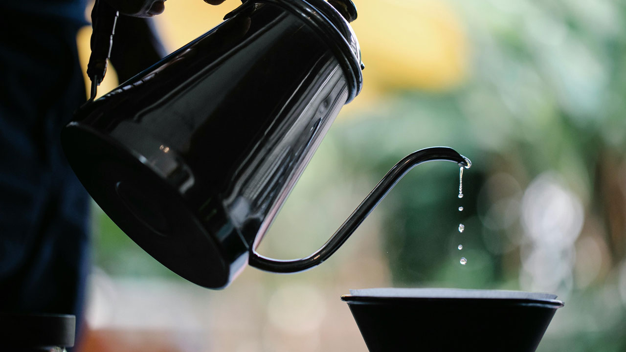 Water pouring into a cup from a kettle. Photo: Michael Burrows.