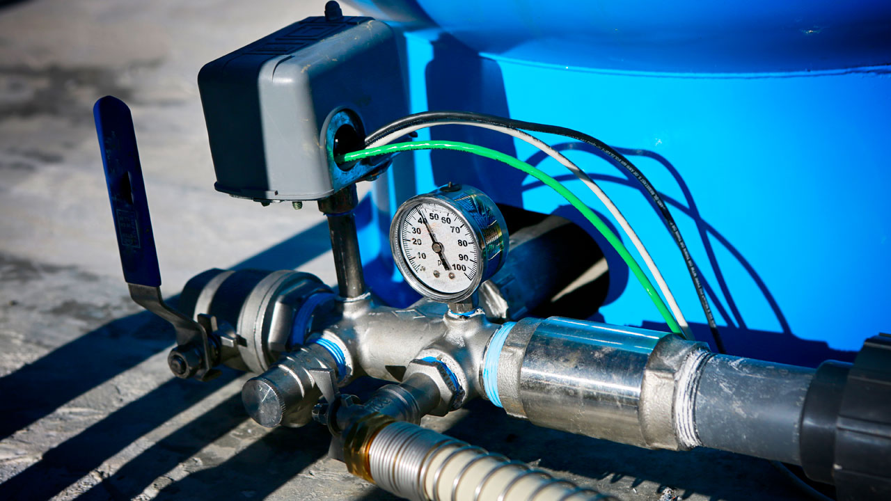 Water pressure indicator on a home pressure tank for a well pump showing psi.