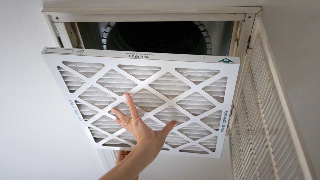 A clean pleated filter replacement at a ceiling air vent