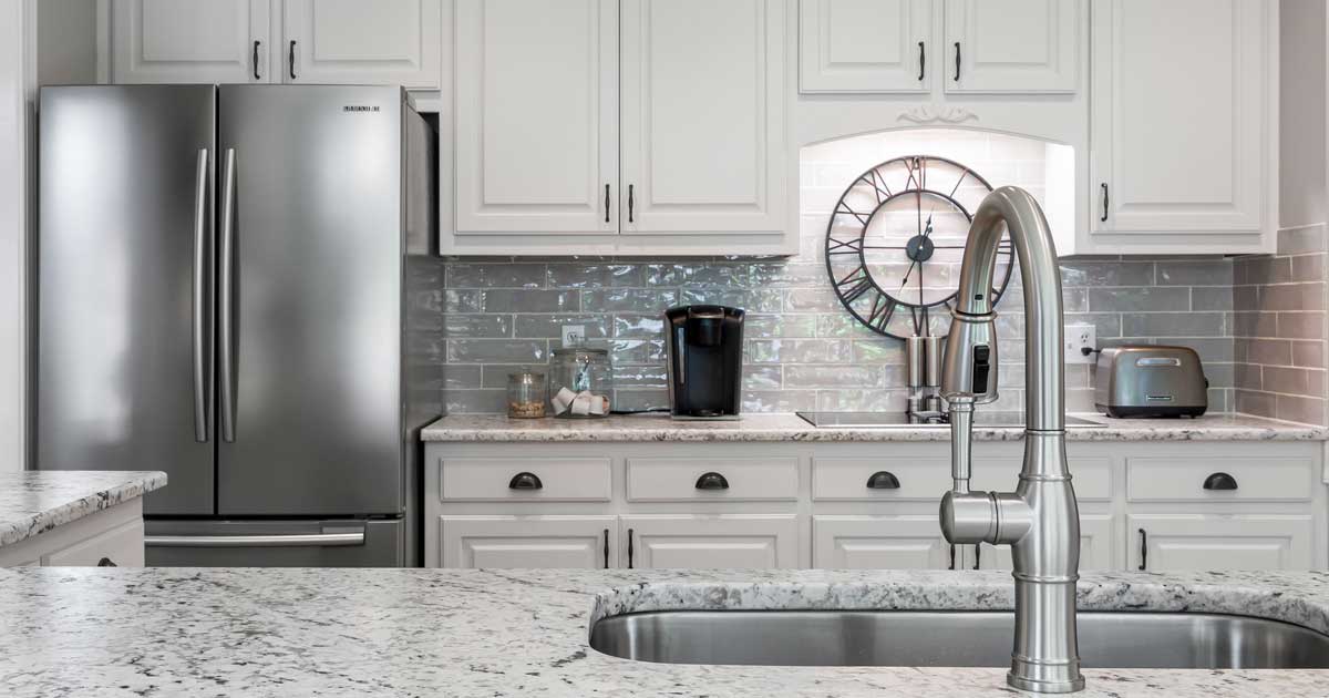 A modern kitchen with a Samsung refrigerator answering samsung water filter how to replace question photo by Curtis Adams courtesy Pexels