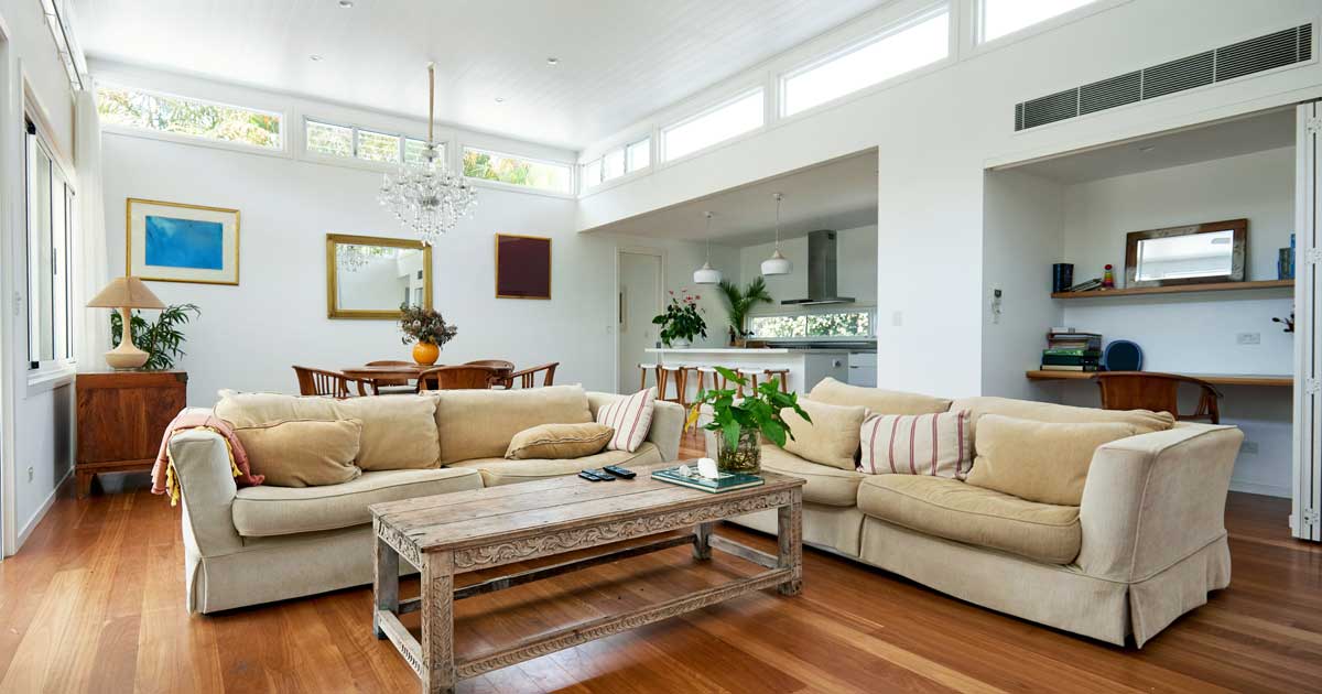 A well organized bright living area with a large vent near the ceiling line and good indoor air quality